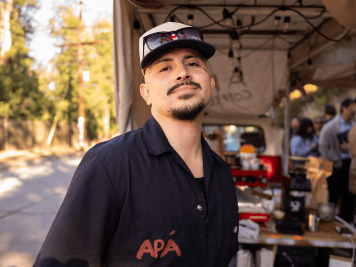 a man with a goatee and cap outside