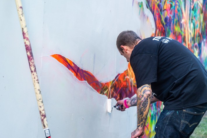 a man painting a mural