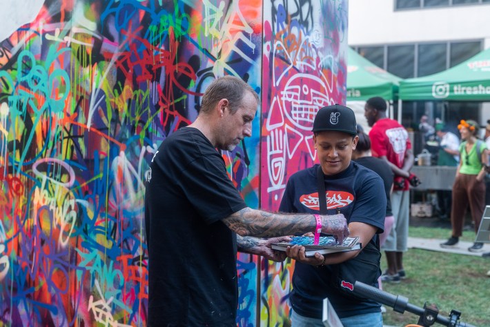 a man and a young person at a graffiti wall
