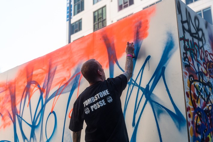 a man paints a large wall