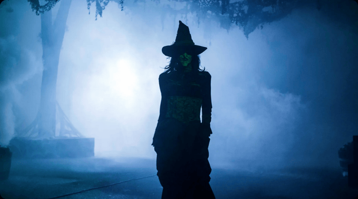 a scareactor dressed as a witch at a haunt