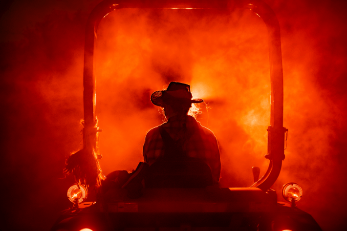 a spooky farmer rides a tractor during the L.A. Haunted Hayride