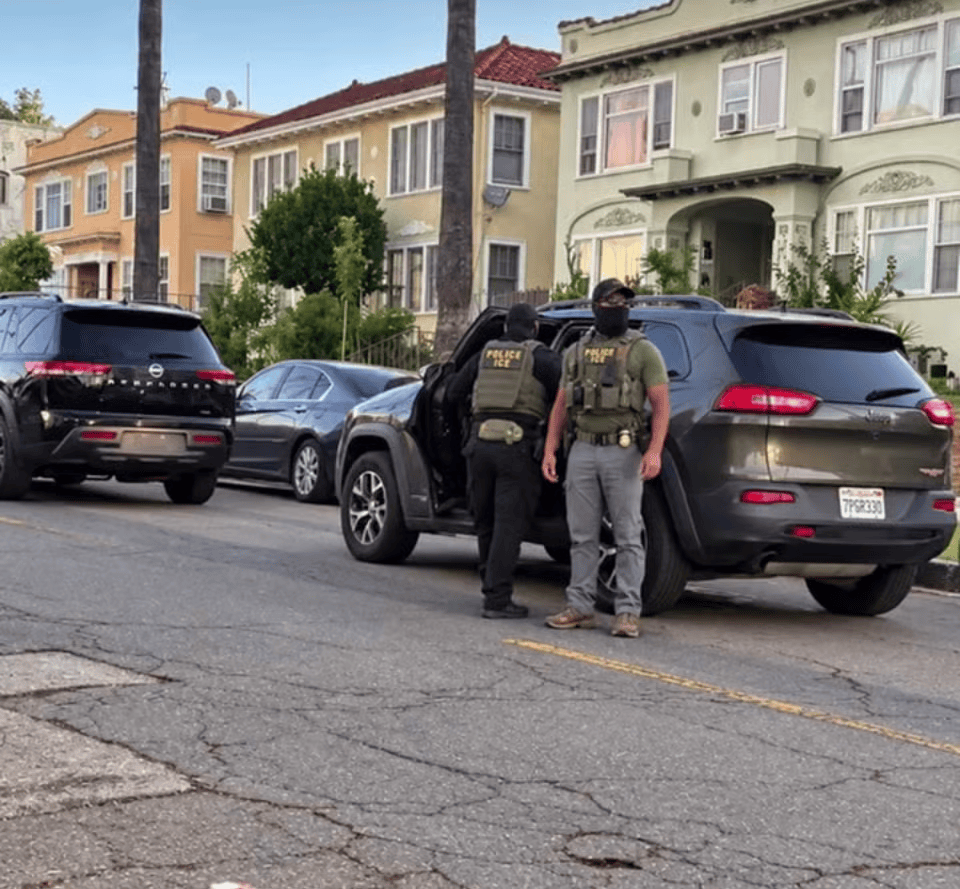 a federal agent stands outside his vehicle