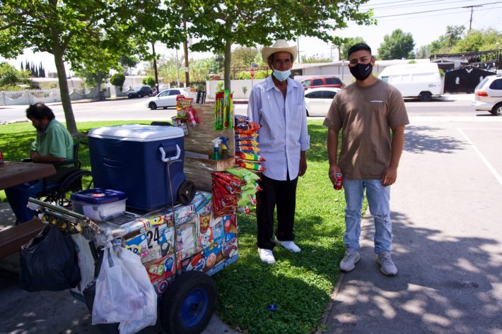 Vazquez stands next to the 24-year-old barber who has helped him during these difficult times. Their conversations began over a cold Coca-Cola.