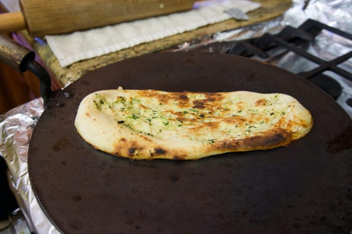 Garlic naan being toasted.