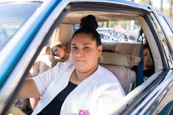 Women driving their lowriders.