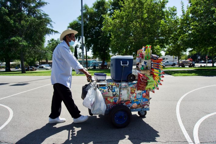 Don Max pushing his push cart.