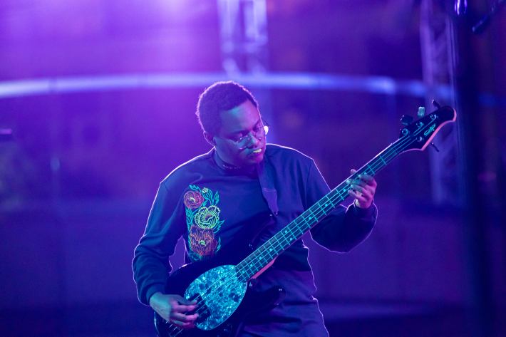 Dan Grubb (bassist/guitarist) lays down a groove as part of Madame Gandhi's musical entourage photo by Sandy Altamirano