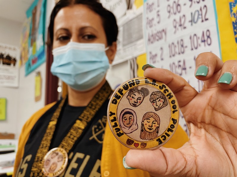 Ms. Huerta holds up a Students Deserve pin that reads "Fully Defund LA School Police" the pin is a part of a district-wide effort being led by LAUSD students.