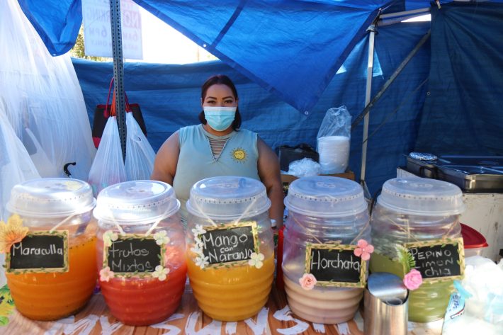 Arely Tafolla Garcia who sells aguas frescas right outside the LACC Swapmeet is one of the vendors who solely relies on her weekend sales to care for her and her family. She vends next to her mother and sister's stand where they sell tacos, pozole, and guisados.