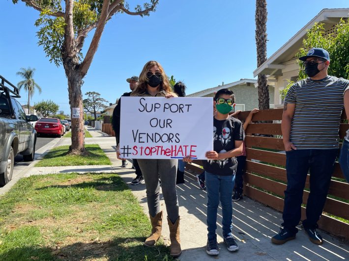 A supporter holds up a sign in support of street vendors. Photo by Janette Villafana for L.A. TACO.