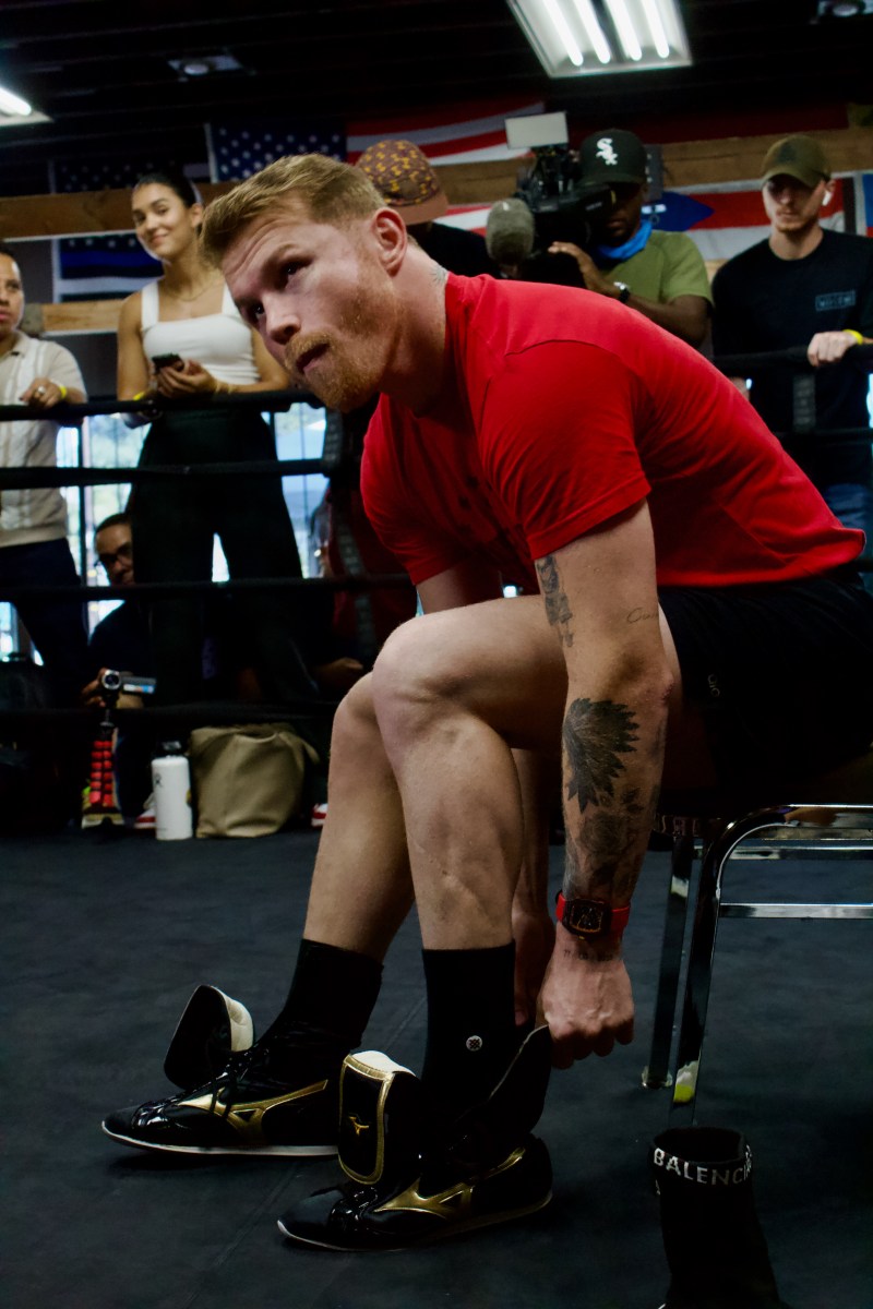 Canelo tightening his laces in San Diego press event. Photo by Ivan Fernandez for L.A. TACO.