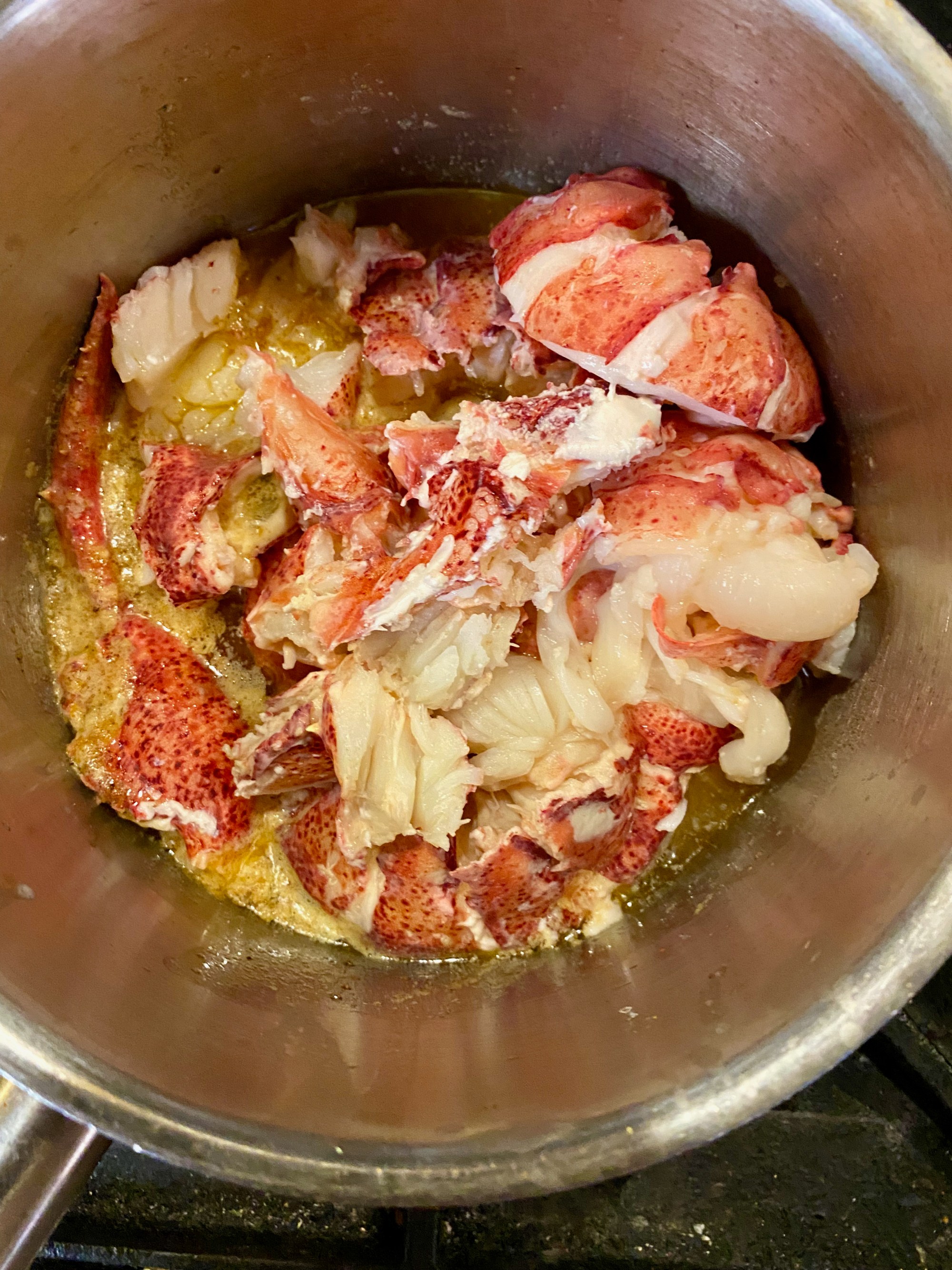 Lobster sitting in butter. Photo by Wes Avila.