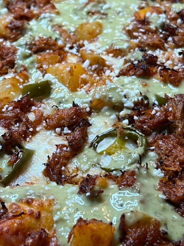 The pinapple al pastor pizza with Herdez Avocado hot sauce.  Photos by Esteban Rey Jimenez for L.A. TACO.