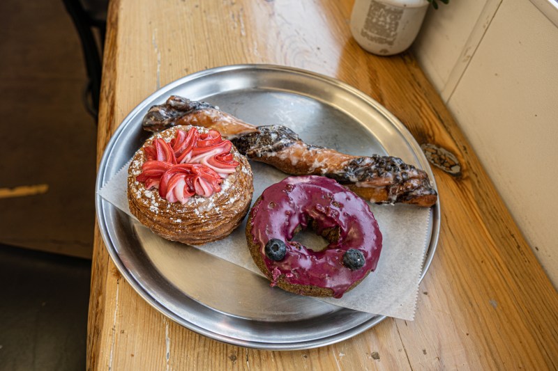 A Tiger Tail, Blue Berry Donut, and Guava Cream Cheese Cronut at Knead Donuts.