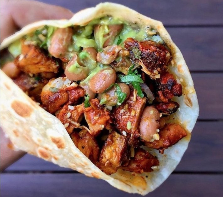 A chicken and pinto bean taco on a flour tortilla at Loqui taqueria