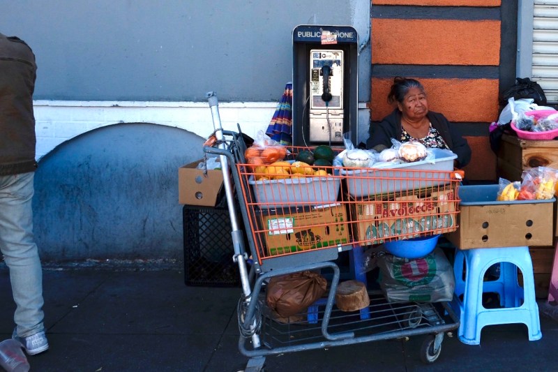 A street vendor sets up shop with her assortment of fruits and vegetables in the Pico-Union district of Los Angeles.