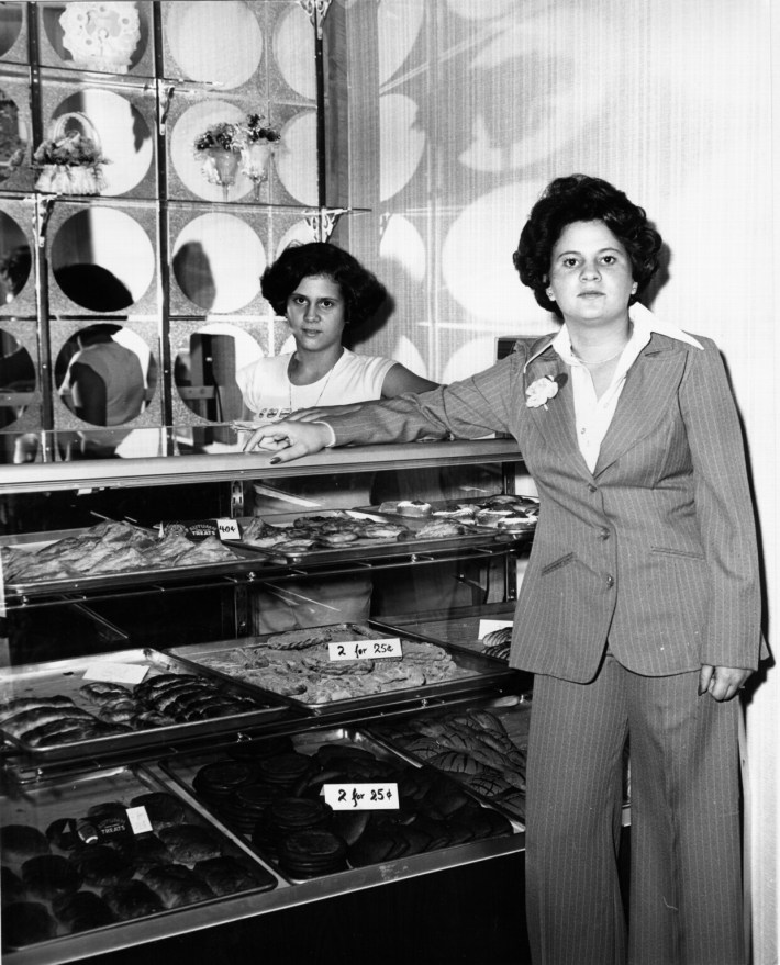 Rosa Porto posing in front of her then-new bakery. Photo courtesy of Porto's Bakery.