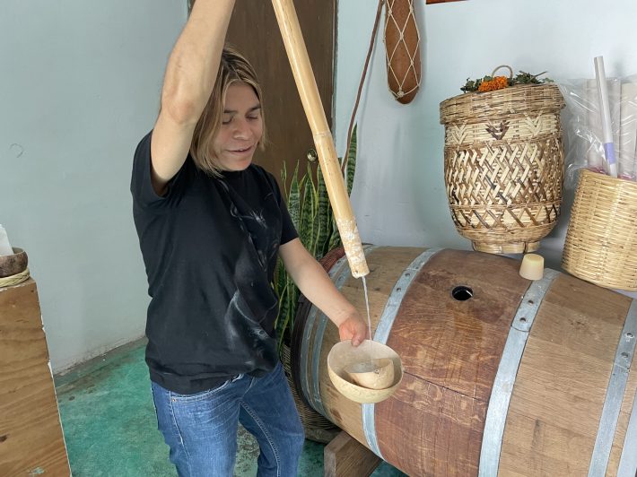 Reina Cortés Cortés pouring pulque at her bar in Santiago de Matatlán, Oaxaca.