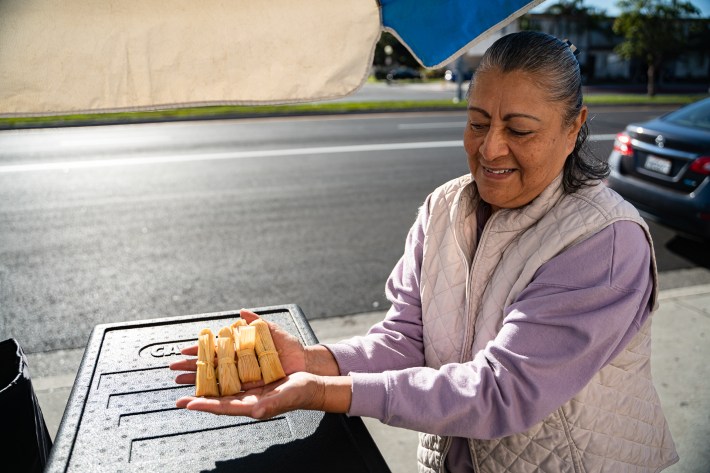 Tiny tamales in the hands of vendor Irma Yolanda Perez