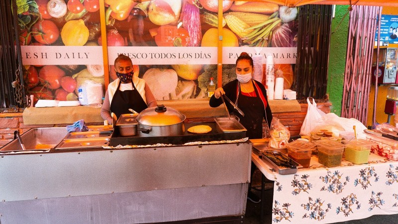 Juana Dominguez, right, in her past street vending setup. Photo by Janette Villafana for L.A. TACO.