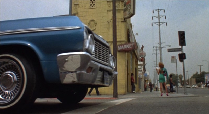 A lowrider spies the redheaded girl in a green dress. Photo via Universal Pictures.
