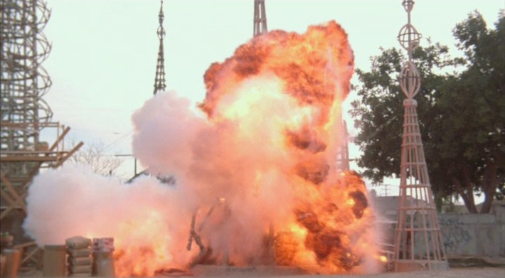Car explodes at Watts Towers. Screenshot via Orion Pictures.
