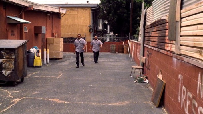 Craig and Day-Day walk through the strip mall’s back alley. Photo via New Line Cinema.