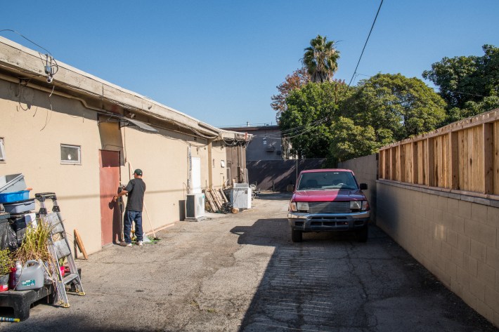 A handyman repairs the backdoor of Ford’s Feathers. Photo by Jared Cowan for L.A. TACO.