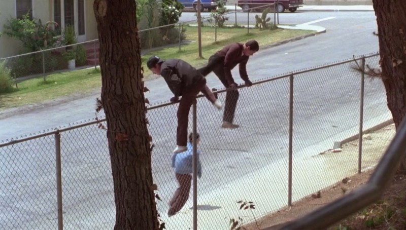 Gang members jump the school fence. Photo via Warner Bros. Pictures.
