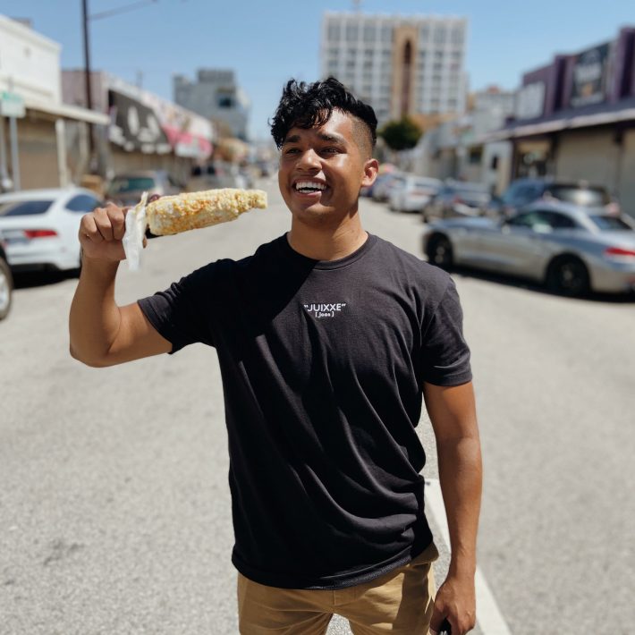 Jesus Morales eats an elote.